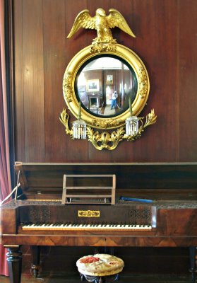 Square piano and extravagant mirror
