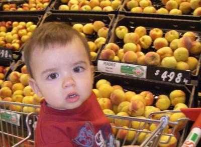 Charlie in the supermarket with peaches