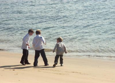 Three small boys on a beach