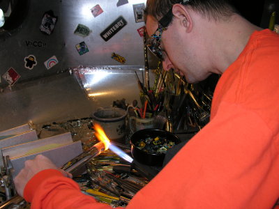 After marvering to a conical shape, Devin applies millies to the cone.