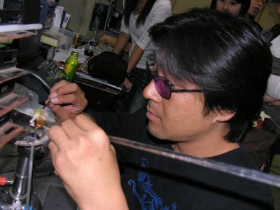 Aki at work on a Japanese torch, using very soft satake glass to make a bead. Look, you can't even see the flame...