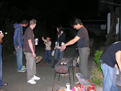 Aki, master grill chef, trying to get those coals going.  That's his wife Hiromi in the background, with his energetic youngest.