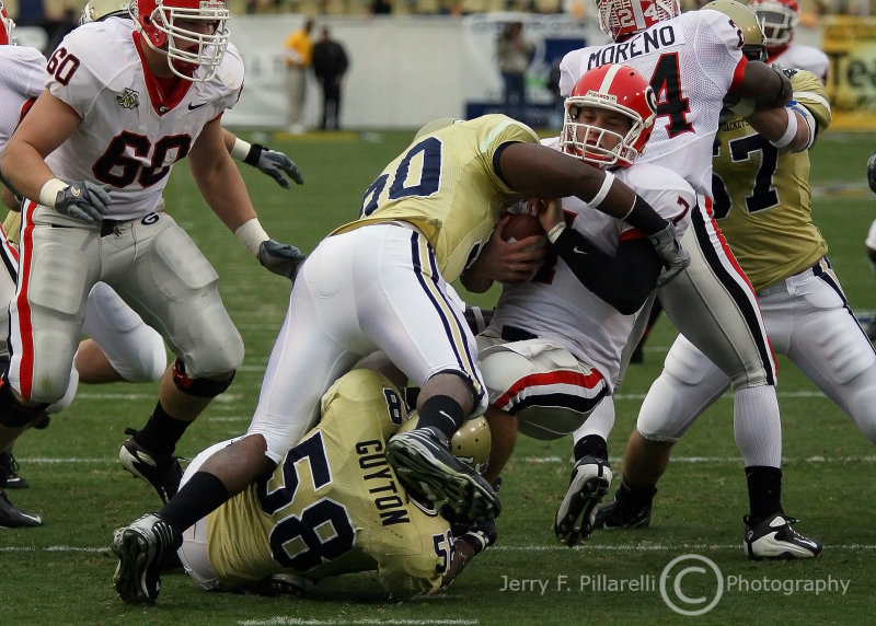 and Tech DE Darrell Robertson drives him to the ground to record the sack