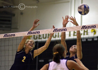 Michigan MB Beth Karpiak attempts to assist a teammate at the net
