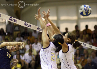 Tech OH Kellogg and MH Callie Miller attempt to block a ball hit by UM MB Courtney Fletcher