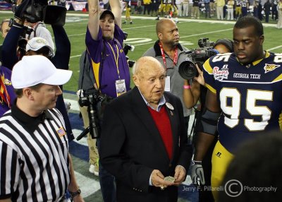 Chick-fil-a founder Truett Cathy performs the coin toss at midfield prior to the kickoff