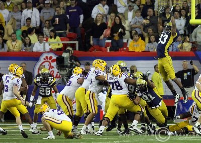 Yellow Jackets DE Michael Johnson leaps to attempt a block of the LSU extra point