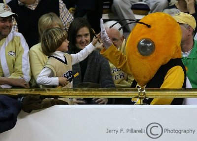 Georgia Tech mascot Buzz high-fives a young Yellow Jackets fan