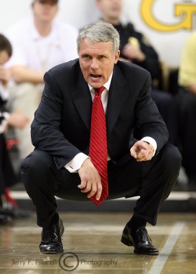 Maryland Terrapins Head Coach Gary Williams talks with his assistants as he watches the game