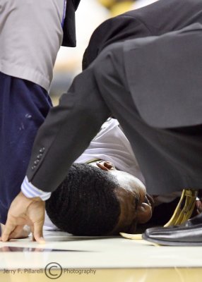 Yellow Jackets G Shumpert winces in pain and is assisted by Tech medical staff