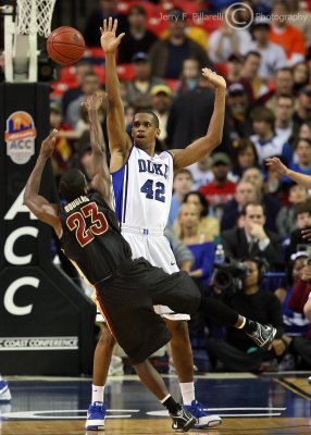 Blue Devils F Thomas holds his ground as Seminoles G Douglas takes an off balance shot from the top of the key
