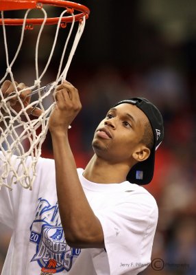 Blue Devils F Thomas takes a piece of the net after his team won the ACC Tournament