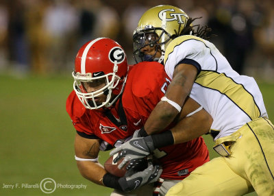 Tech S Morgan Burnett tackles and tries to pull the ball away from Bulldogs TE Aron White