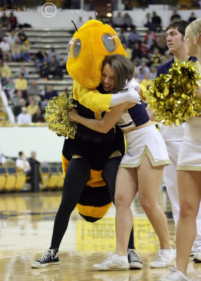 Georgia Tech Yellow Jackets Cheerleader gets a hug from Buzz