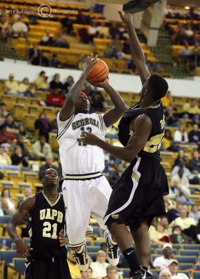 Yellow Jackets G DAndre Bell shoots from the baseline over Golden Lions F Davis