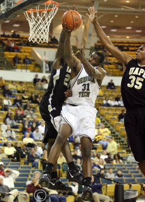 Jackets F Lawal lays the ball up under heavy defensive pressure