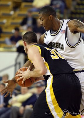 Yellow Jackets F Derrick Favors applies tight defense to Owls F Nickerson