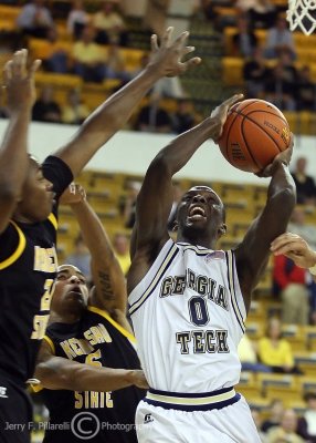 Georgia Tech G Mfon Udofia goes in for a layup against two Owls defenders