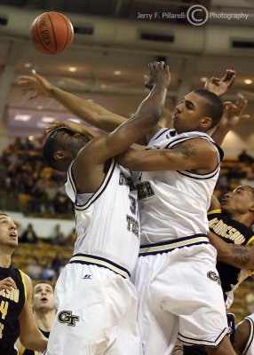Tech F Gani Lawal gets an accidental forearm to the face from teammate Glen Rice Jr. as they both fight for a rebound
