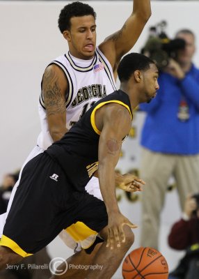 Jackets F Oliver gets in front of driving Owls G Kurtis Woods