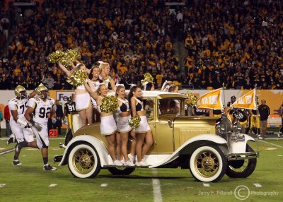 The Ramblin Wreck from Georgia Tech leads the team onto the Orange Bowl field
