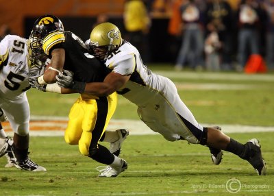 Jackets DT Jason Peters tackles Hawkeyes RB Robinson in the backfield for a loss