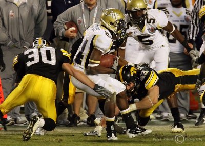 Jackets A-back Embry Peeples is gang tackled by Hawkeyes defenders