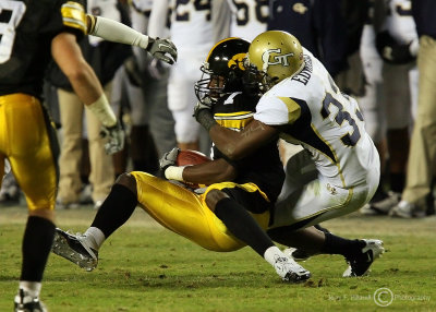 Yellow Jackets DB Mario Edwards brings down Hawkeyes WR McNutt after a catch