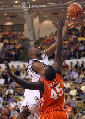 Tech F Lawal goes strong to the basket against Tigers F Grant