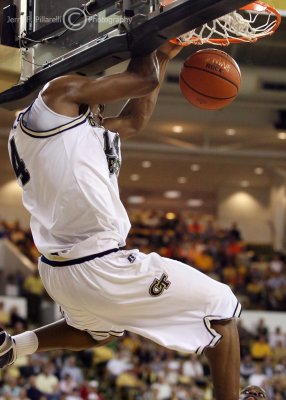 Yellow Jackets F Favors hangs on the rim after a slam dunk
