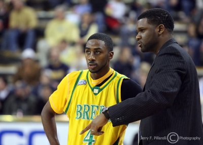 Kentucky State Interim Head Coach and former Jackets player Clarence Moore talks to G Gay during a timeout