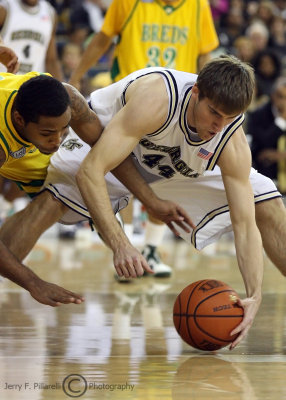 Jackets F Shew scrambles for a loose ball