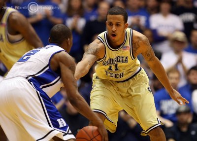 Jackets F Brian Oliver defends against Blue Devils G Smith