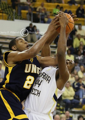 Jackets F Alade Aminu takes one on the chin from UNCG F Sellers