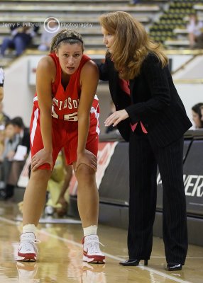 Wildcats Head Coach Watts instructs F Paquette during a break in the action