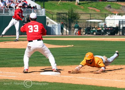 UT 3B Brown dives back to first to avoid the pick off