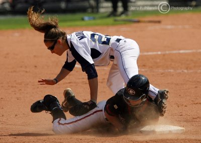 Georgia Tech SS Aileen Morales is upended after putting the tag on a sliding Bulldogs base runner