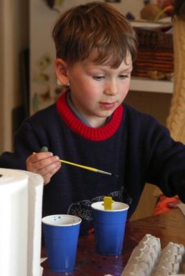 Eggs are painted indoors.