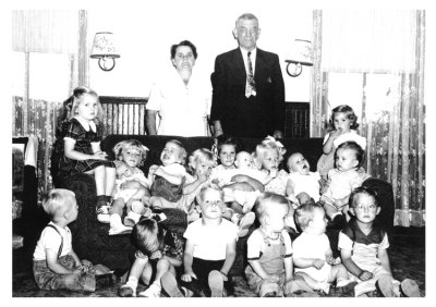 Tillie & Everett Robinson are seen standing with their grandchildren. Shown left to right, top to bottom we see: Judy Wood, Donna & Harold Robinson, Linda Wood, JoAnne, Alice, Bonnie, & Sandy Robinson, Susie King, Diane Gerren, Nancy Wood, Butch Hetrick, Roy Robinson, Duane Gerren, Slug Wood, John Hetrick & Teddy King.   