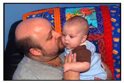 Vati steals a few kisses from his son.