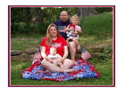 Happy 4th of July, 2009. Little Isaac was blinded by the sun, and Hazelmarie had her best half smile pasted on. Left to right we see Mama, Salena Marie, holding little Isaac. In the back we see Vati, Richard holding Hazelmarie. Mama made that blanket just for this picture, although, as usual, it will end up on the bed of Her Majesty, Hazelmarie.