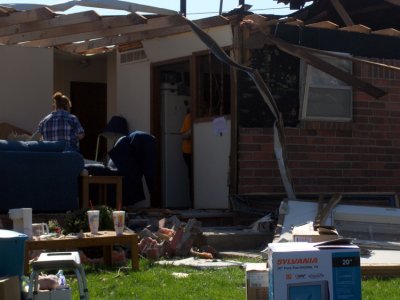 Shown are the owners, doing what they can to salvage what's left of their home.