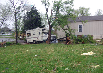 While roofs were ripped from there footings, & buildings demolished to the foundation, this RV didn't even move from its parking spot along side this house. The pressure was so great however, that the windows were all blown out.