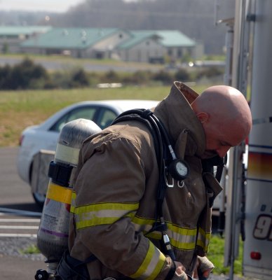 A firefighter checks his equipment prior to starting