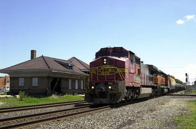BNSF power on a westbound by the old station at Deshler