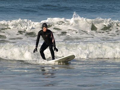 This is one of my best, because we have to capture these surfers with the morning sun to be able to see the face. In cloudy and rainy Oregon, this doesn't happen a lot for two reasons. First we don't have a lot of clear days in the morning. Even if we don't have clouds, we can have morning fog. The second reason, is that a lot of the surfers don't hit the water until late morning or afternoon. With some patience, I was able to capture this one with the 40-150mm kit lens at Ecola State Park, Oregon. I would really like to capture one like this...with a surfer riding the waves...with the rocks and abandoned lighthouse in the background. Then I will feel I got something special.