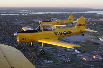 Three plane formation with the Stearman and two Chipmunks. We are starting our low and over on runway two five in tight formation.
In the background is the Detroit River and in the upper right is Lake St. Clair. On the other side is Detroit, Michigan, USA.
