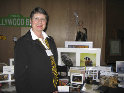 Meggi in front of her table exhibit