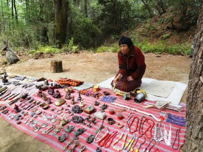 A Bhutanese woman offering her ware on a hand woven cloth