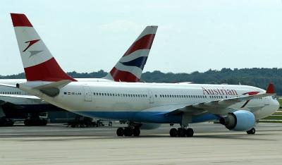Austrian 330 taxi pass BA 777 on its way to its stand, IAD, Aug. 2004